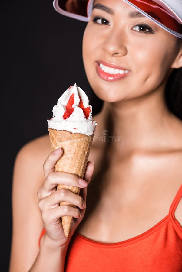 Woman in Swimsuit and Visor Holding Ice-cream Stock Im