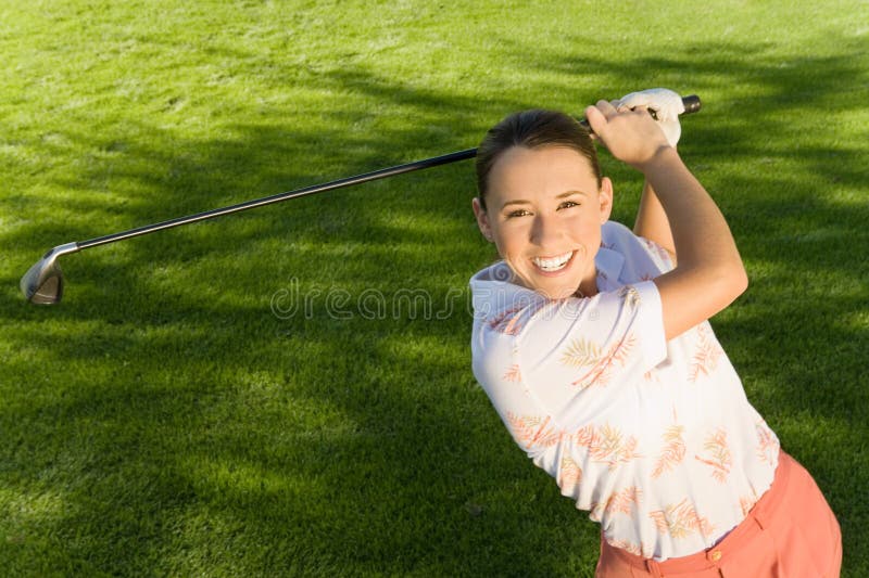 Woman Swinging Golf Club stock photo. Image of beautiful 29646358