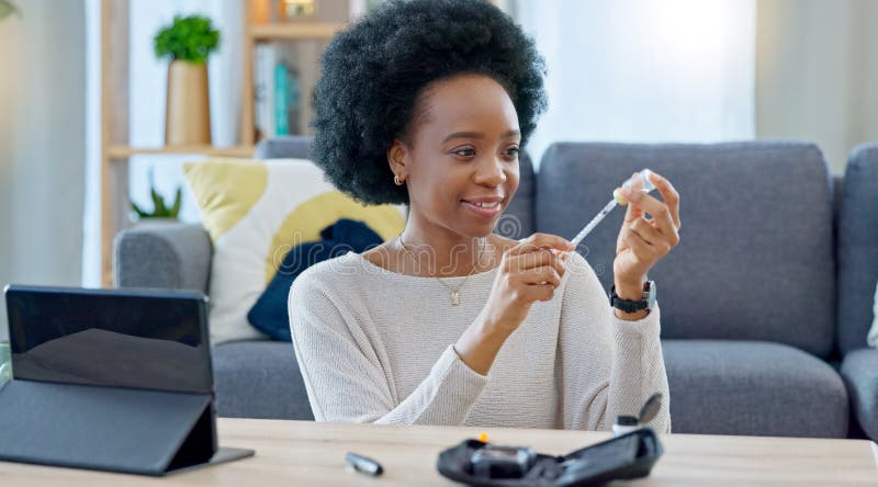 Woman with syringe preparing an insulin injection at home with an online tutorial. One girl injecting self with medicine