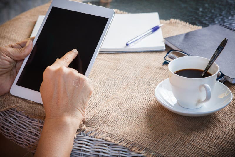 Woman and tablet computer in hand sliding on touching screen use