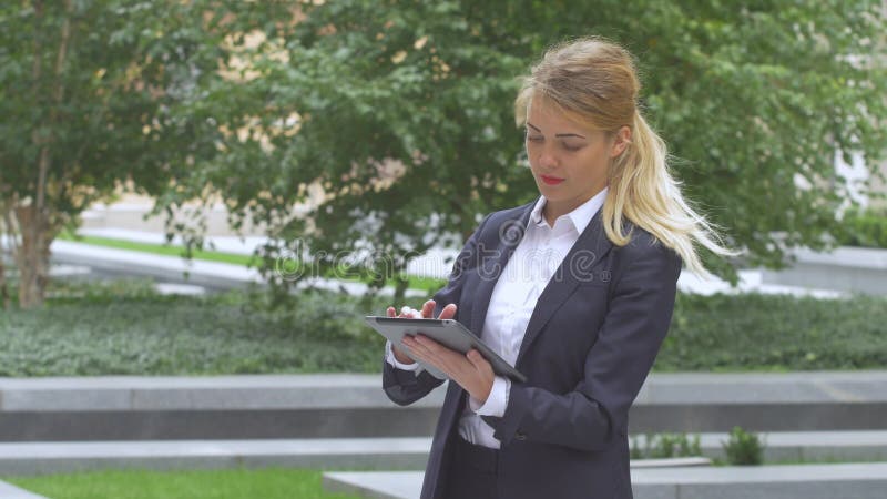 Woman with tablet computer near office building. close up