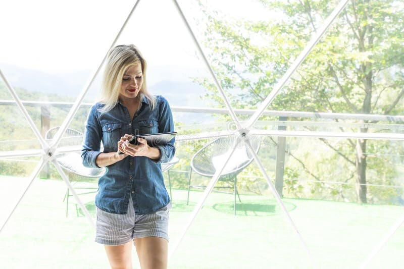 Woman with tablet in dome tent stock images