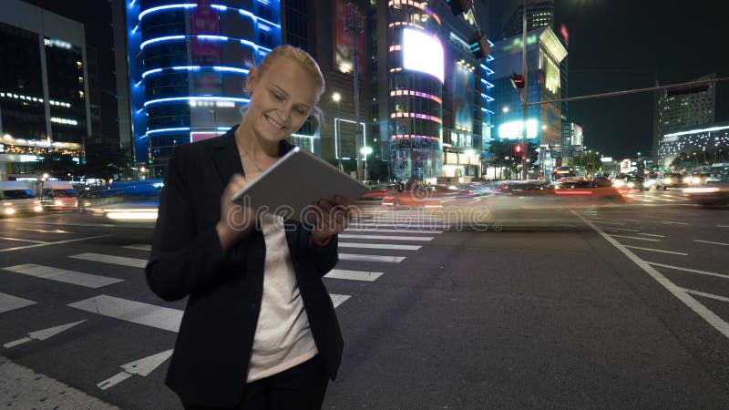 Woman with tablet PC in night Seoul, South Korea royalty free stock photography Woman with tablet PC in night Seoul, South Korea royalty free stock photography