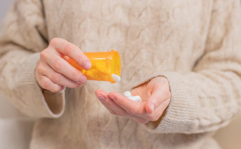 Woman takes pills vitamins. Woman is holding a jar of pills her hands