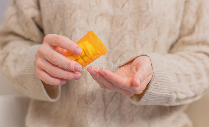 Woman takes pills vitamins. Woman is holding a jar of pills her hands