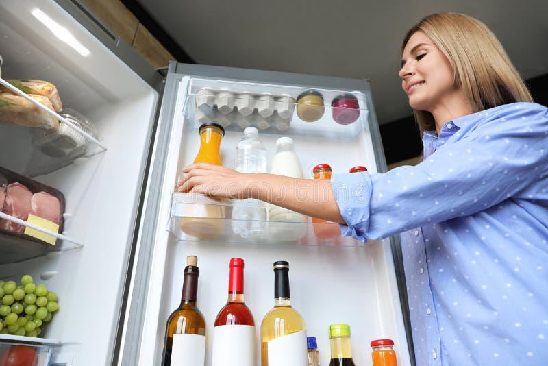 Woman Taking Bottle with Juice Out of Refrigerator Stock Image - Image ...