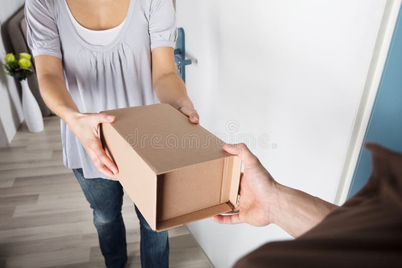 Woman Taking Box From Delivery Man royalty free stock images Woman Taking Box From Delivery Man royalty free stock images
