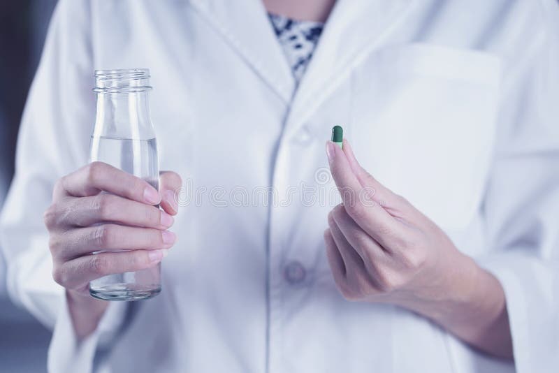 Woman are taking and eating medicines and vitamins for help sick and healthy stock image Woman are taking and eating medicines and vitamins for help sick and healthy stock image