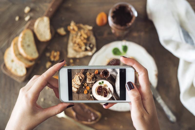 Woman taking a photo of breakfast table royalty free stock photography Woman taking a photo of breakfast table royalty free stock photography