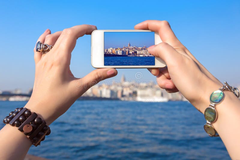 Woman taking Photo with camera phone in Istanbul city