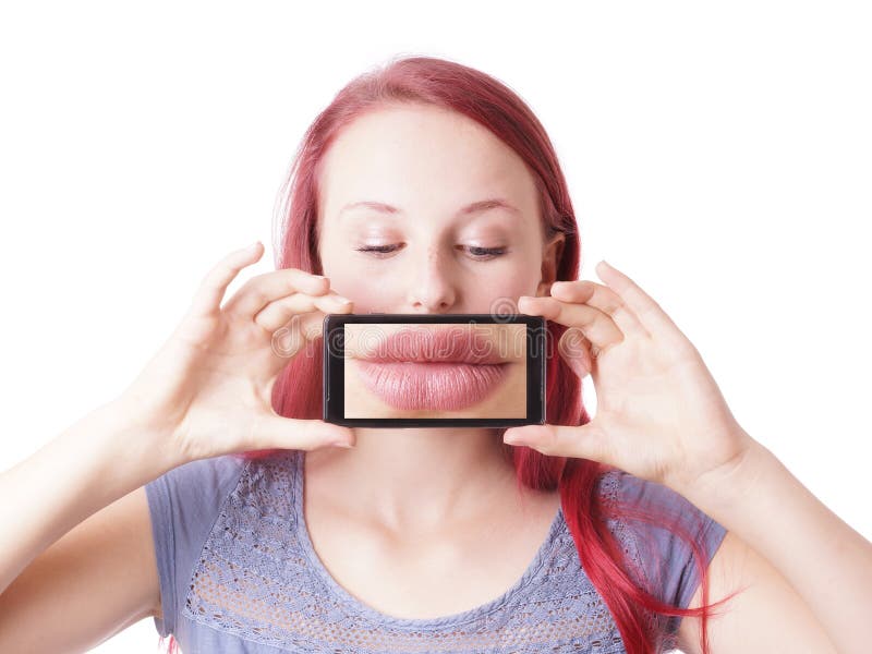 Young woman messing around with camera phone taking picture of her own lips. Young woman messing around with camera phone taking picture of her own lips