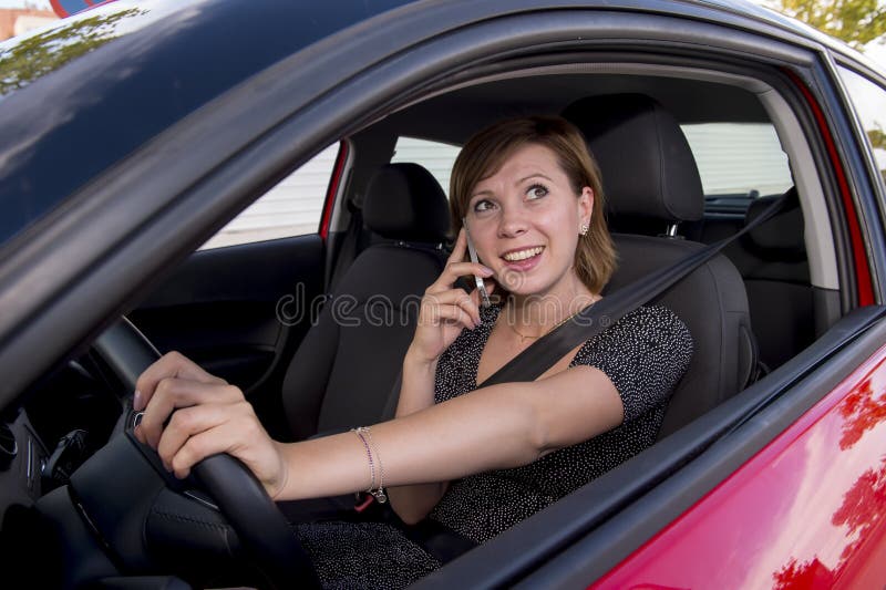 Worried And Stressed Woman Driving Car While Texting On Mobile Phone