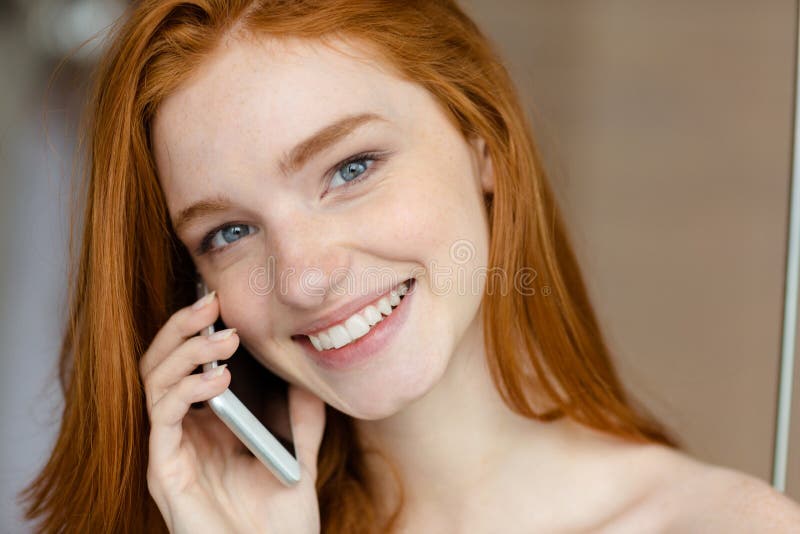 Woman talking on the phone and looking at camera stock images