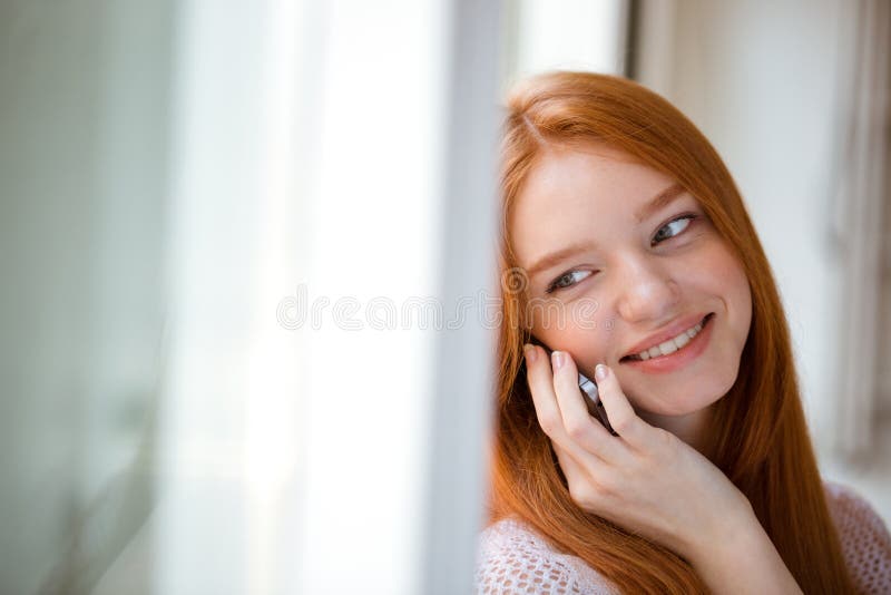 Woman talking on the phone and looking at camera royalty free stock image