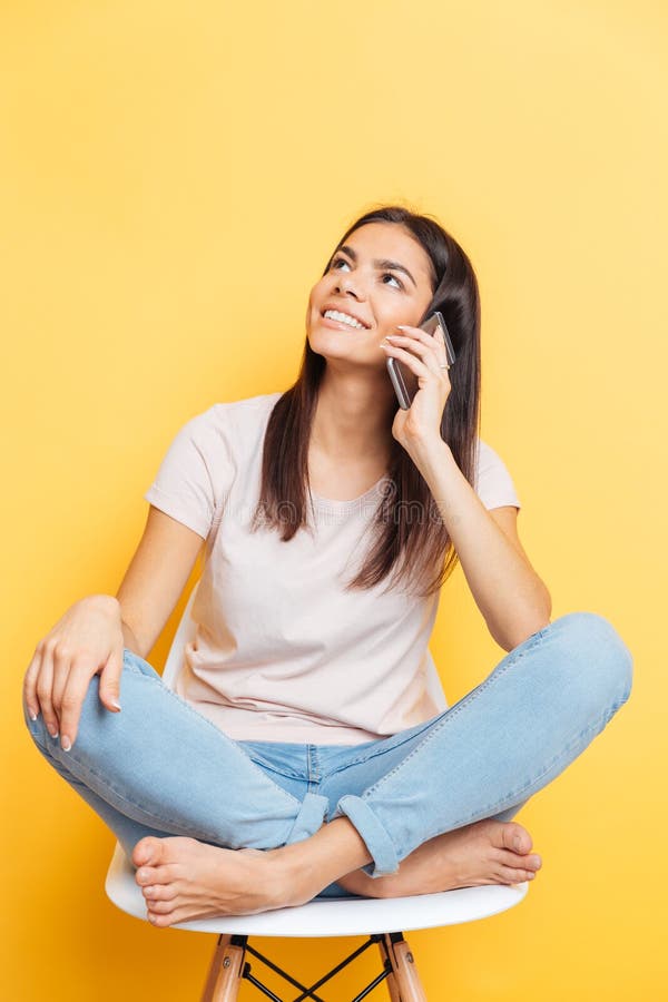 Woman talking on the phone and looking up stock photo