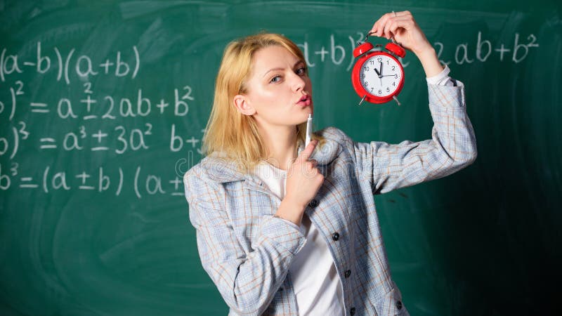 Woman teacher hold alarm clock. Girl formal wear school lecturer. Time to study. Welcome teacher school year.