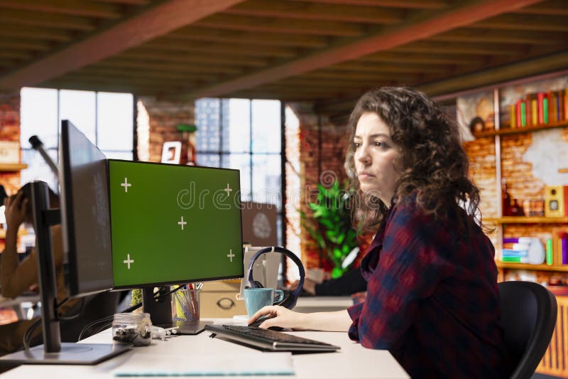 Woman in tech startup office using AI systems on chroma key PC stock image