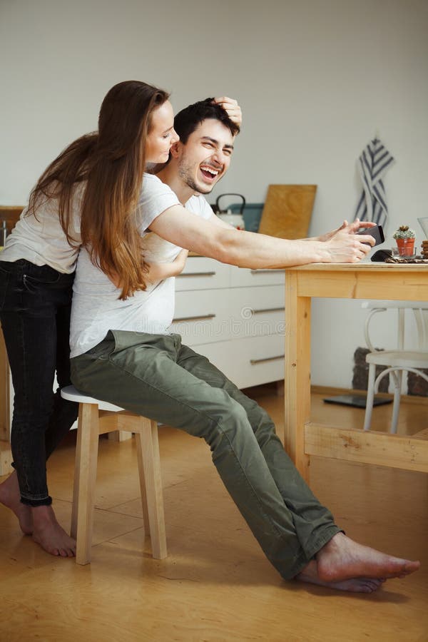 Woman Tenderly Holds Her Mans Hair Hugging Him From Back Stock Image Image Of Table Women