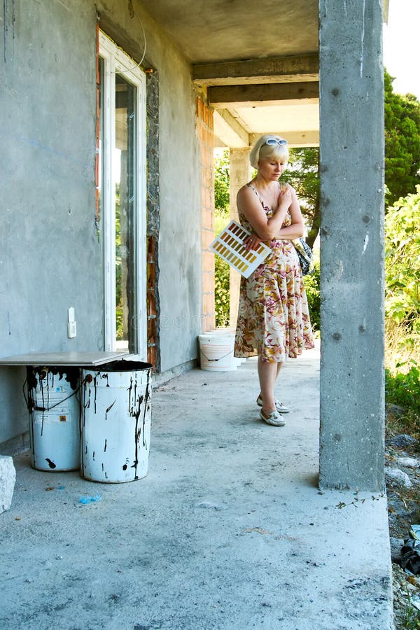 Blond woman thinking about the constructing house. Blond woman thinking about the constructing house