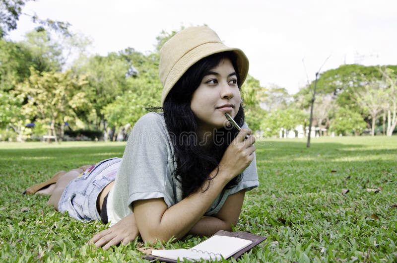 Woman thinking hard studying outside