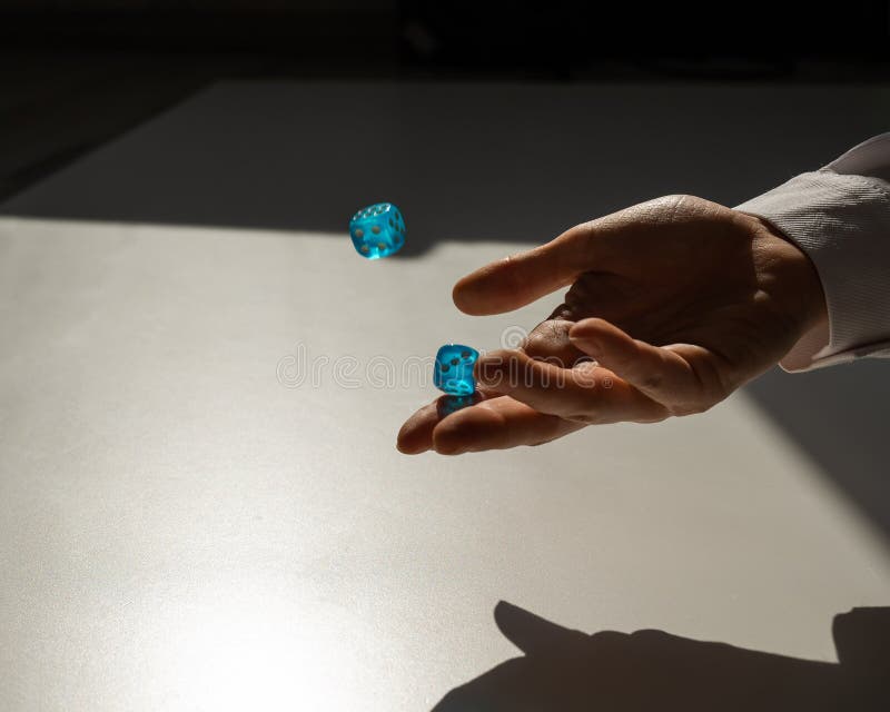 Woman Throws a Pair of Blue Transparent Dice. Stock Image Image of