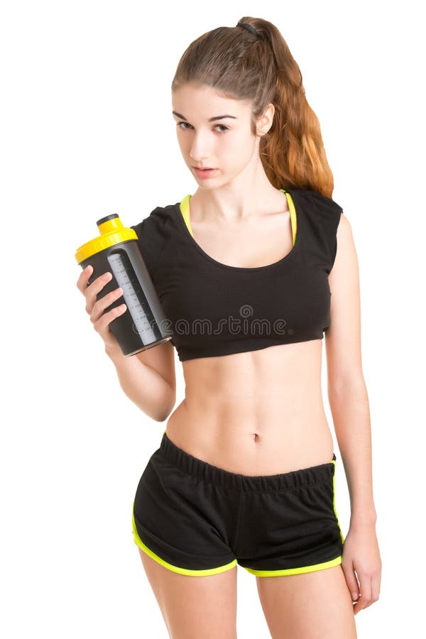 Cute athletic girl in sportswear with protein shake isolated on