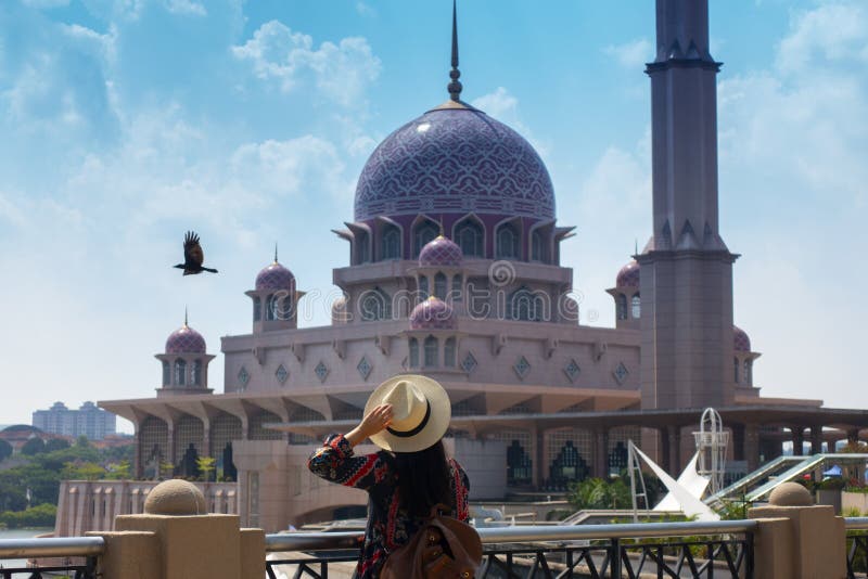 Woman tourist is sightseeing Putrajaya Mosque during travel stock photo Woman tourist is sightseeing Putrajaya Mosque during travel stock photo