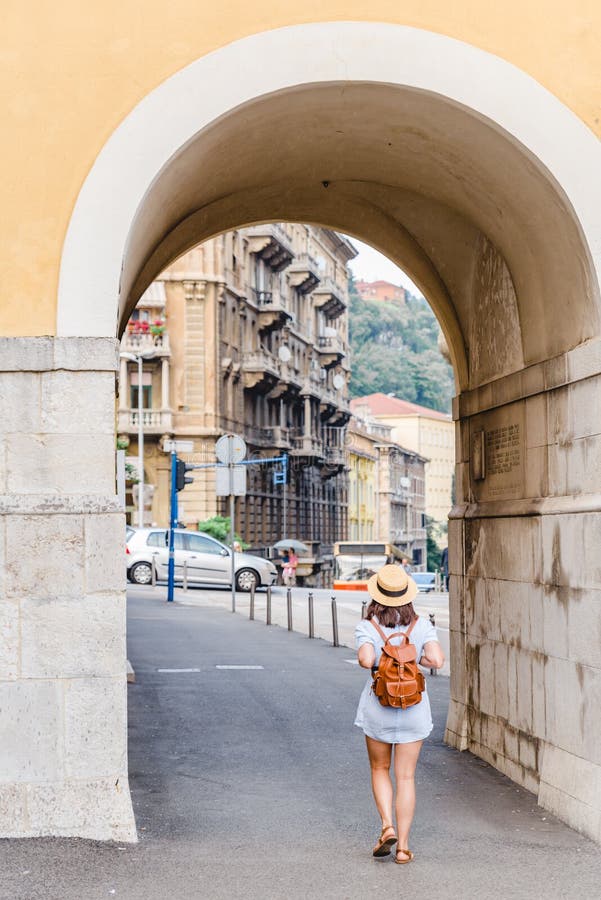 woman tourist walking by Rijeka city street