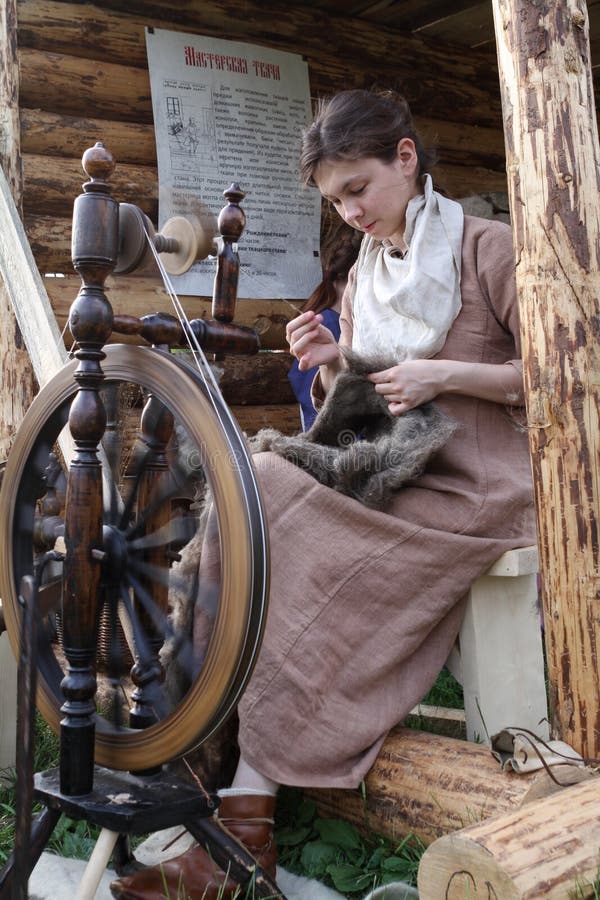 Woman At Spinning Wheel Making Yarn Stock Photo, Picture and