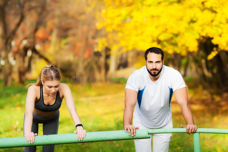 Woman training with personal trainer at park royalty free stock photo Woman training with personal trainer at park royalty free stock photo