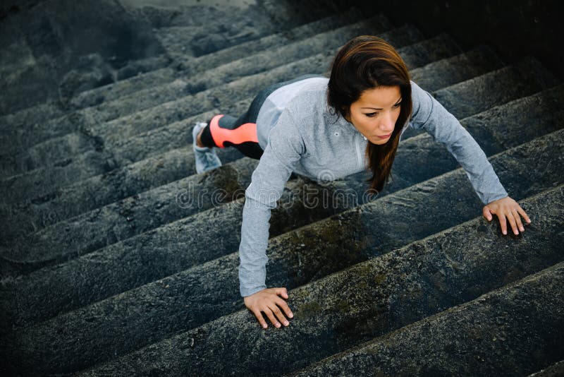 Woman training stairs push ups on urban workout stock images Woman training stairs push ups on urban workout stock images