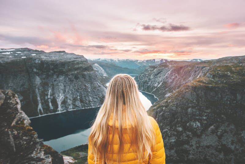 Woman traveling alone enjoying sunset mountains