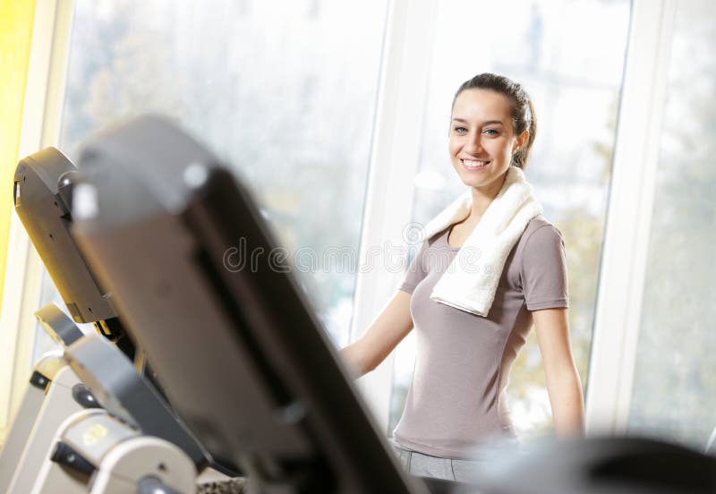 Woman on treadmills stock image. Image of club, hair 23804099
