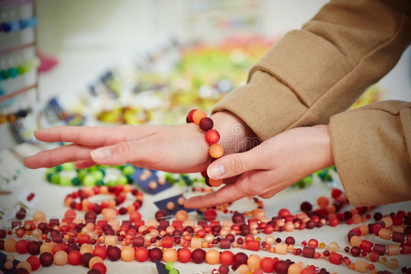 Woman trying on bracelet at jewelry