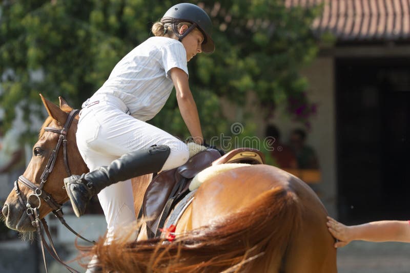 Woman trying to mount horse