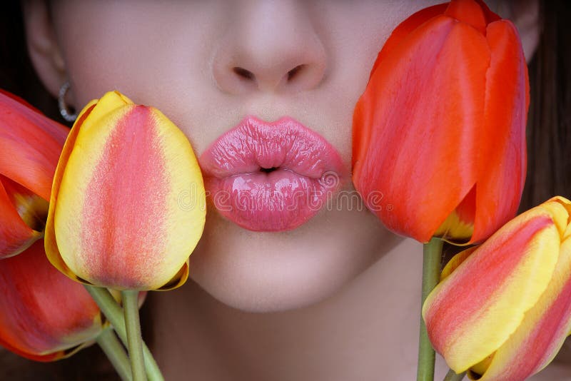 Woman with tulips kiss. Sensual lips. Kissing. 8 march women`s day.