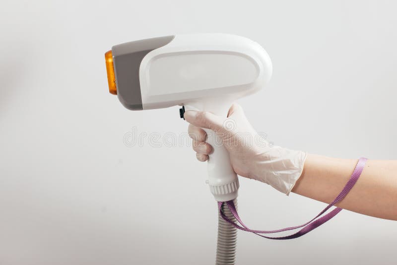 A Woman Tunes a Laser Hair Removal Machine. she Holds a Working Part of the  Epilator in Her Hands and Poses for a Photo Stock Photo - Image of modern,  cosmetology: 167497012