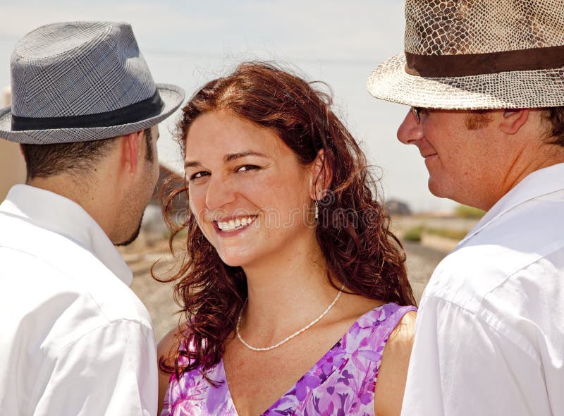 Woman with two men representing a romantic triangle or a polyamory (polyamorous) relationship