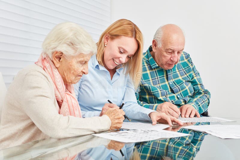 Woman and two seniors are doing memory training stock photo Woman and two seniors are doing memory training stock photo