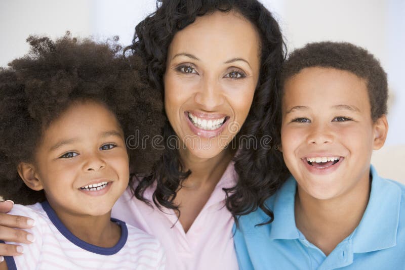 Close up of woman and two young children smiling