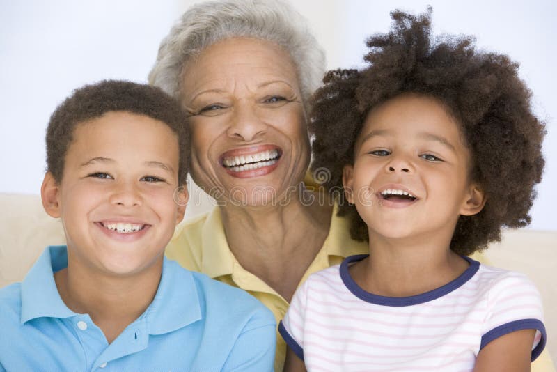 Close up of woman and two young children smiling