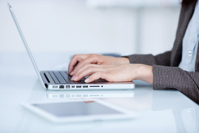Woman typing on her laptop royalty free stock images