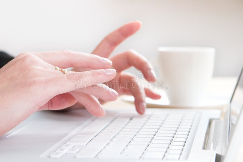 A woman typing on a laptop