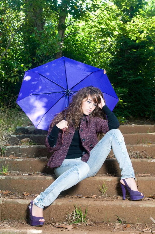 Woman with umbrella in a park in fall