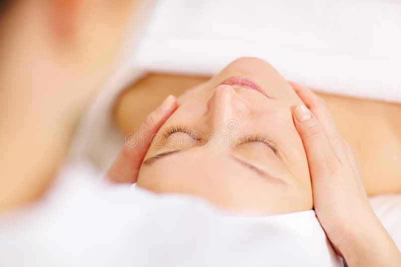 Close-up shot of a women during the seance of facial massage in beauty spa. Close-up shot of a women during the seance of facial massage in beauty spa.