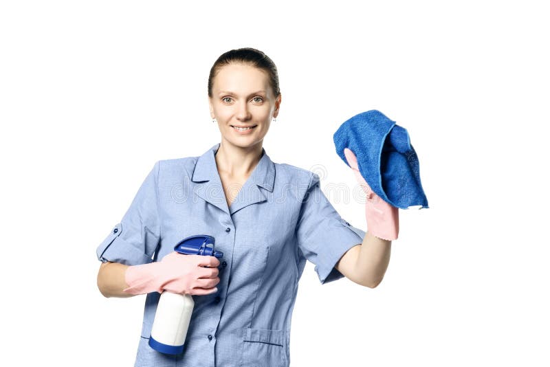 A woman in the uniform of a maid holds a rag and spray for washing windows and looks at them in surprise. Isolated on a white background. Washes glass