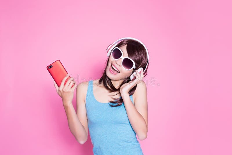 Woman use phone listen music on the pink background