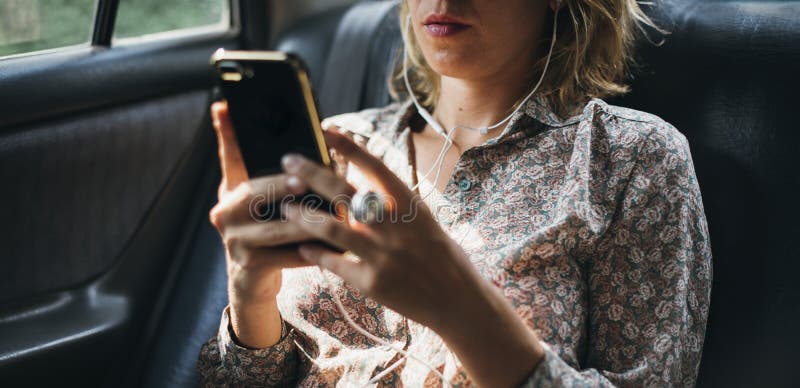 Woman using her phone in a car stock photography Woman using her phone in a car stock photography