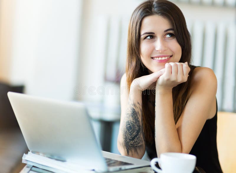 Woman using laptop at cafe stock photography