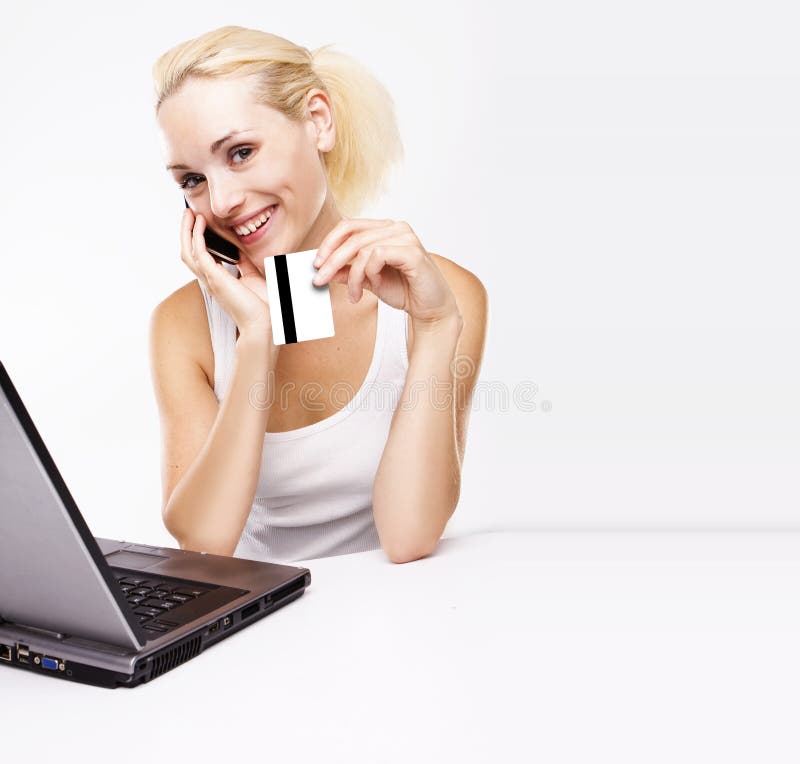 Woman using laptop, holding credit card